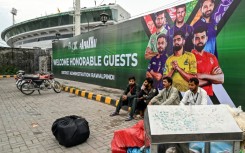 Vendors pack their belongings as they leave Rawalpindi Cricket Stadium following the postponement of Thursday's match in the PSL