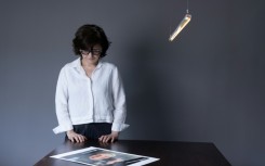 Iranian filmmaker and activist Sepideh Farsi looks at a portrait of the Palestinian photographer Fatima Hassouna, who was killed in the bombing of her house in the Gaza Strip