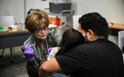 Administering the measles vaccine to a child at a health center in Lubbock, Texas