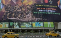 Taxis drive past a hoarding on the main gate of Eden Gardens in Calcutta acknowledging the efforts of the Indian armed forces during the recent India-Pakistan conflict