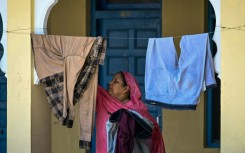 A displaced woman hangs clothes to dry at a Sikh temple in Jammu, a key city in Indian-administered Kashmir
