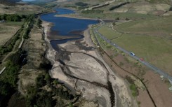An aerial photo shows the bed of Woodhead Reservoir is partially revealed by falling water levels, near Glossop, northern England as the country experiences its driest start to spring in 69 years