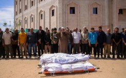 Mourners pray for the dead after Israeli strikes in Gaza