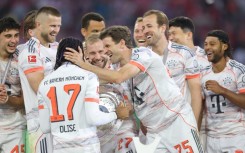 Bayern Munich's players congratulate Michael Olise after winning the league title.