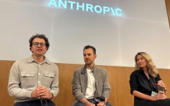 Anthropic CEO Dario Amodei (l) says people are going to eventually have to cope with AI systems being able to handle just about any task a human can handle
