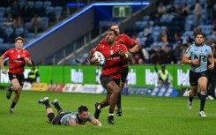 Canterbury Crusaders' Sevu Reece (C) runs the ball for a try during a Super Rugby match against the New South Wales' Waratahs in Sydney on May 16, 2025