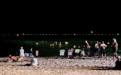 Dubai residents attempt to cool off at night at the Umm Suqeim beach as temperatures sizzle above 50 degrees Celsius (112 Fahrenheit)