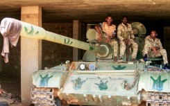 Sudanese soldiers on a tank after they captured a base used by the RSF in the Salha area of Omdurman, on May 26