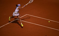 Poland's Iga Swiatek swept past Britain's Emma Raducanu in the second round to keep her bid for a fourth straight French Open title on track