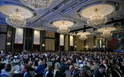 Attendees watch France's President Emmanuel Macron's address at the Shangri-La Dialogue Summit in Singapore
