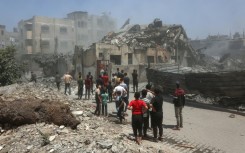 Palestinians inspect the rubble following Israeli strikes on a family home in Al-Tuffah neighbourhood in Gaza City