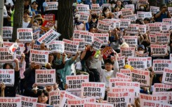 People hold placards that read 'Let's not forget the December 3 insurrection' during a campaign rally ahead of South Korea's June 3 poll