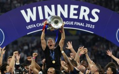 Paris Saint-Germain coach Luis Enrique lifts the Champions League trophy after his side outclassed Inter Milan in the final