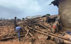 People picked through debris from damaged buildings in Mokwa