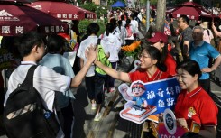 While teachers and staff offered students their support, holding up signs of encouragement, some test takers, dressed in school uniforms, appeared panicked