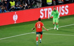 Ruben Neves runs toward Portugal's goalkeeper Diogo Costa after netting the winning penalty