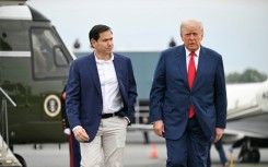 US President Donald Trump (R), seen here with Secretary of State Marco Rubio, has slapped a travel ban on a dozen countries