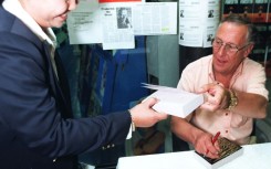 Frederick Forsyth in Bangkok in 1997, signing copies of his novel 'Icon'