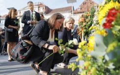 Mourners cried, hugged and left flowers, candles and letters to the victims in Graz