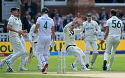 Australia's Mitchell Starc celebrates with Steve Smith (C) after dismissing South Africa's Aiden Markram
