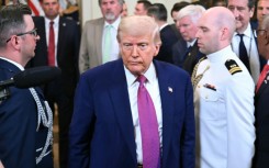 US President Donald Trump departs after signing a bill in the East Room of the White House