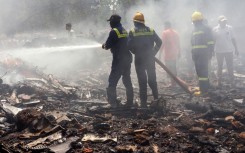 A huge plume of smoke rising from the crash site of the Air India plane