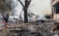 Firefighters work at the site where Air India flight 171 crashed