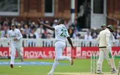 South Africa's Kagiso Rabada (C) celebrates taking the wicket of Australia's Usman Khawaja
