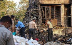 Rescuer workers and investigators comb through the crash site