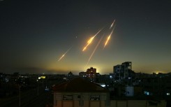 Missiles streak across the sky, as seen from the Gaza Strip