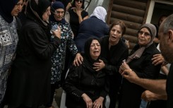 The mother of a victim of an Iranian missile attack that hit the Arab town on Tamra in northern Israel, during the funeral
