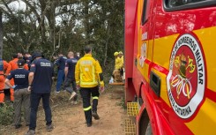 Brazilian rescue teams comb the spot in Praia Grande where a hot air balloon erupted in flames, killing at least eight people