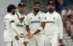 India's Jasprit Bumrah (C) celebrates with team-mates after dismissing England's Chris Woakes in the first Test at Headingley
