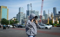 Beijing officials encouraged people to limit outdoor activity and drink fluids to avoid heastroke