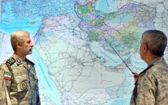 A handout picture provided by the Iranian Army media office shows army chief Amir Hatami (L) at his war command room