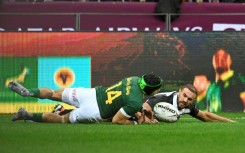 South Africa winger Cheslin Kolbe (L) scores against the Barbarians at Cape Town Stadium