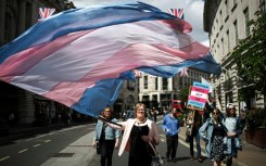 A protester with a transgender pride flag during a march in London in May 2025