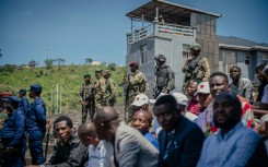 M23 rfighters stand guard during a service organized by rebels' administration at a stadium in Goma on May 18, 2025