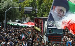 This picture obtained from Iran's ISNA news agency shows a funeral procession of 15 people killed in Israeli strikes in the city of Mashhad on Friday