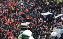 The funeral procession winds its way across the sprawling Iranian capital through crowds of black-clad mourners.