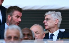 FIFA's Arsene Wenger talks with David Beckham during the Club World Cup's opening match between Egypt's Al Ahly and Inter Miami at the Hard Rock stadium
