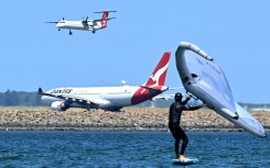A Qantas plane waits to take off at Sydney International Airport