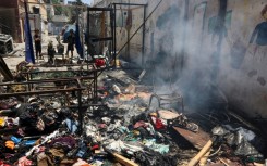Piles of debris smouldered in the Gaza City school compound hit on Thursday