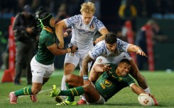 South Africa full-back Damian Willemse (R) under pressure from Italy centre Tommaso Menoncello (2nd R) in Pretoria.