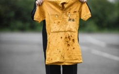 French cyclist Jacques Marinelli, who has died aged 99, holds the yellow jersey he wore for six days in the 1949 Tour de France in which he finished third