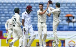 Josh Hazlewood (2R) celebrates removing West Indies opener Kraigg Brathwaite for a duck