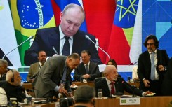 Russia's President Vladimir Putin is seen projected on a screen during the first plenary session of the BRICS summit in Rio de Janeiro, Brazil, on July 6, 2025.