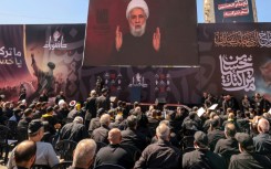 Lebanese Shiite Hezbollah supporters listen to a televised speech by the movemen't leader Naim Qassem during a ceremony during the peak of Ashura