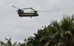 A helicopter flies overhead looking for missing people in Kerrville, Texas