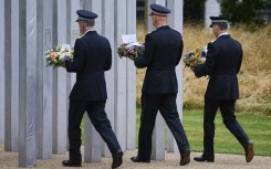 Police officers lay wreaths at the memorial to the July 7 victims in London's Hyde Park